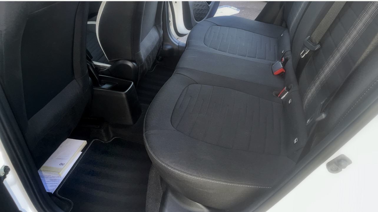 Vacuumed rear seats and carpets in a light-coloured car interior after an SdetailE clean